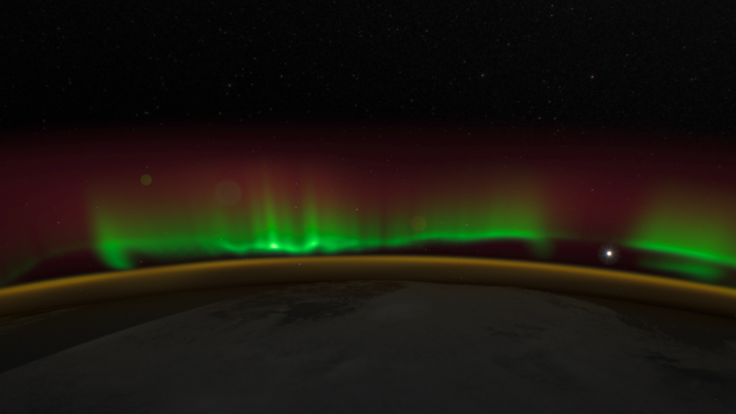 Green folds of aurora with a dark gap below them.