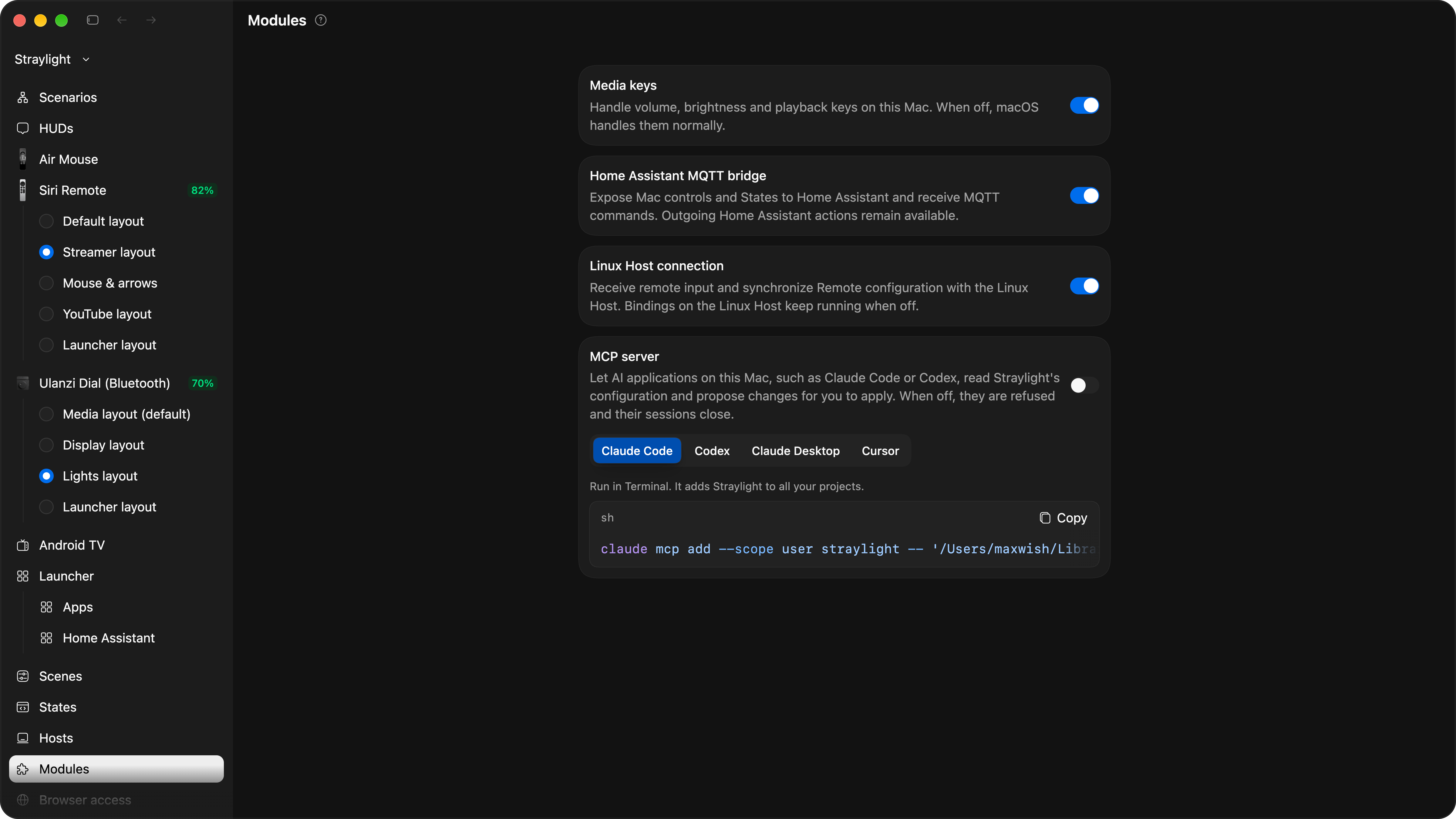The Modules settings page with four switches: Media keys, Home Assistant MQTT bridge and Linux Host connection on, MCP server off, with tabs for Claude Code, Codex, Claude Desktop and Cursor and a command to add Straylight to Claude Code.