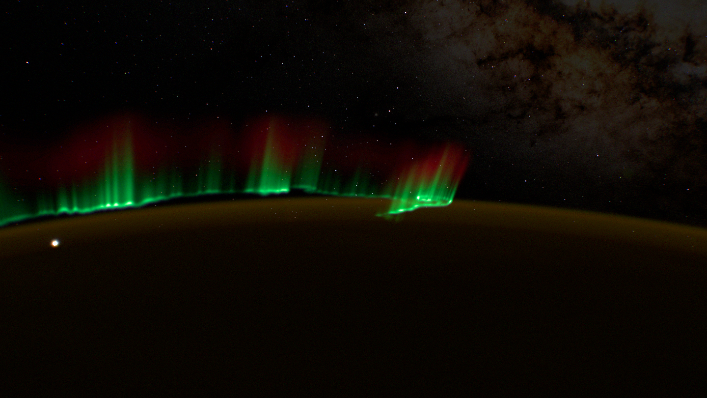 Thin green rays rising from a sharp lower edge.